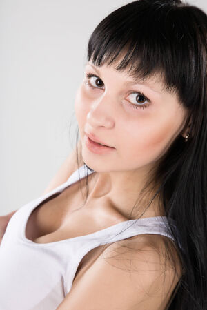 Young attractive brunette in white shirtの写真素材