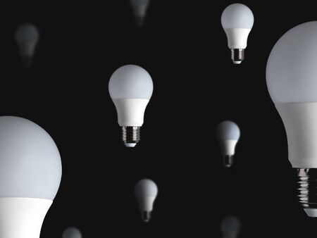 A lot of white light bulbs hanging in the air on black background