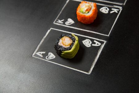 Hand drawn Poker cards with Japanese sushi roll pieces on dark chalkboard background. Asian Roll...