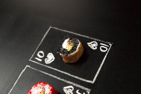 Hand drawn Poker cards with Japanese sushi roll pieces on dark chalkboard background. Asian roll...