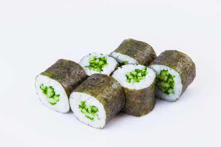 Side view of Vegetarian Japanese Maki Roll with cucumber and rice wrapped in nori seaweed. Close-up of asian traditional vegan dish isolated on gray background. Isolation menu imageの写真素材