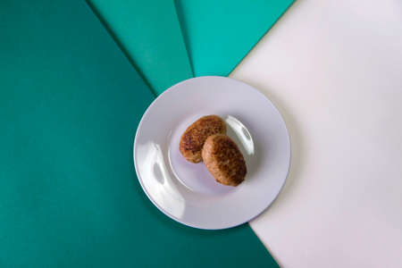 Top view of Two Meatballs served on gray plate. Russian traditional Homemade meat cutlets on colorful blue background. Slavic food menuの写真素材