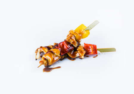 Japanese Calamari Skewers with bell pepper served with sauce. Yakitori Calamari isolated on white background. Pan Asian dish isolation. Kusiyaki seafood with paprikaの写真素材