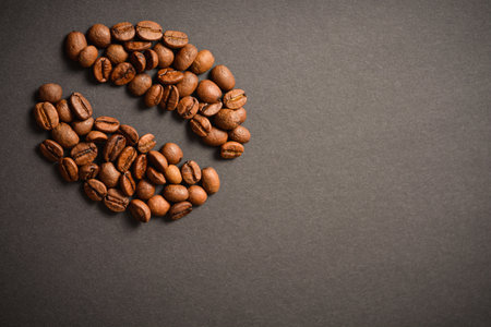 Horizontal background image of Coffee bean shape isolated on dark background. Coffee seed silhouette of roasted high quality coffee beans. Aroma drinkの写真素材