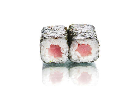 Two pieces of Japanese Maguro Maki sushi roll with nori seaweed with tuna inside roll. Side view of roll dish isolated on white background. Copy space menu image with reflectionの写真素材