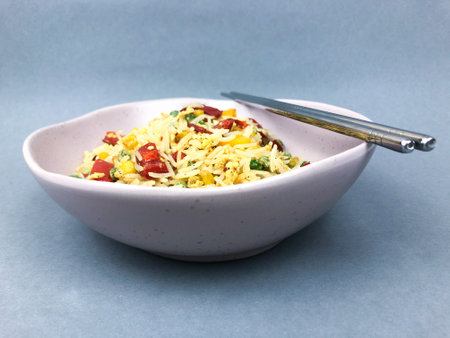 Bowl with Thai fried vegetable rice served with Metal Chopsticksの写真素材