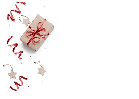 minimalistic christmas composition. Wrapped gift with a red bow  on a white background with Christmas decorations, wrapping ribbon, sparkles stars. top view, copy space, happy new year conceptの写真素材
