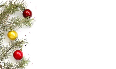 Christmas composition. Christmas tree branches, decorations, pine cones, sparkles stars on a white background. top view, copy space, happy new year conceptの写真素材