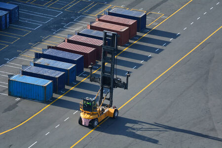 Containers beiong moved on a port road