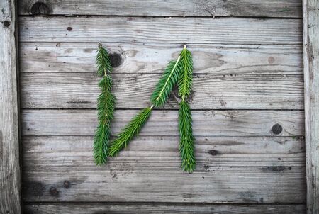 Letter from fir tree branches on aged wooden boardsの写真素材