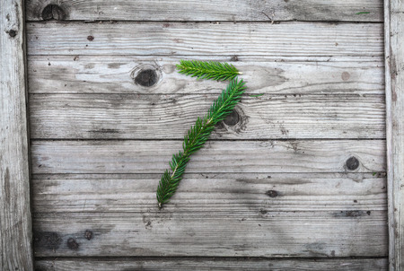 Number 7 from fir tree branches on aged wooden boardsの写真素材