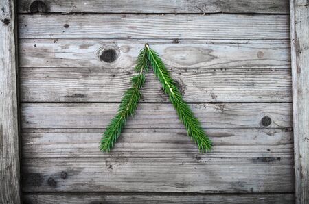 Letter from fir tree branches on aged wooden boardsの写真素材