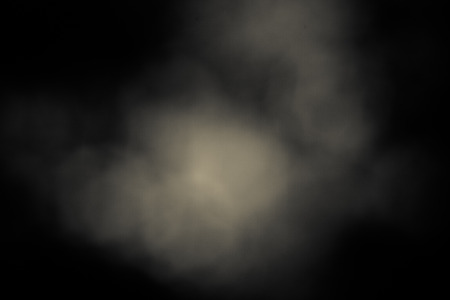 Circular bokeh dark background with creamy white patches of lightの写真素材