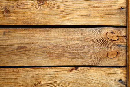 Textured background of ochre painted wooden boardsの写真素材
