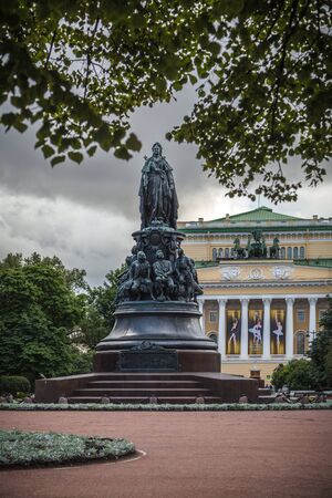 Saint Petersburg, Russia, August, 7, 2017 - Monument to the empress Catherine II at Ostrovsky Square against the background of Alexandrinsky Theatre. There are tree branches on a foreground.のeditorial素材