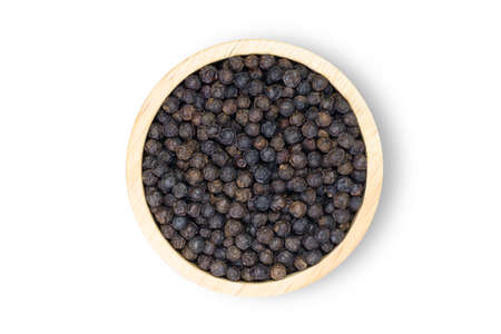 Closeup black pepper seeds or peppercorns ( dried seeds of piper nigrum, piperine ) in wooden bowl...