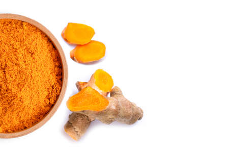 Turmeric powder ( curcumin, Curcuma longa Linn) in wooden bowl with rhizome and slice isolated on white background. Top view. Flat lay. Copy space for text.の写真素材