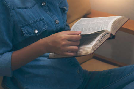 Young asian woman relaxreading book at home. Leisure time and home lifestyle concept.