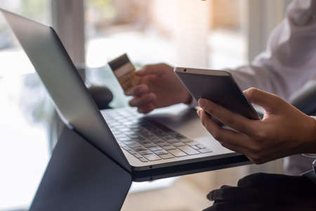 Business woman make online shopping and internet banking on mobile smartphone and laptop computer, payment by credit card. e commerce, e business, mobile banking, online shopping concept.の写真素材