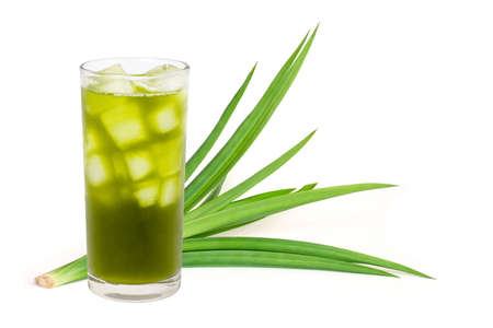 Closeup fresh green pandan leaves and glass of concentrated pandan juice tea isolated on white background . Healthy herbal drinks concept.の写真素材