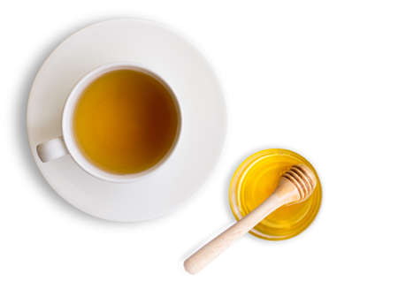 Closeup hot ginger tea in ceramic cup and pure honey in glass jar isolated on white background . Healthy drinks and  food booster immune system concept. Top view. Flat lay.の写真素材