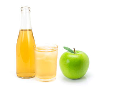 Close up bottle and glass of apple cider vinegar and green granny smith apple isolated on white background.の写真素材