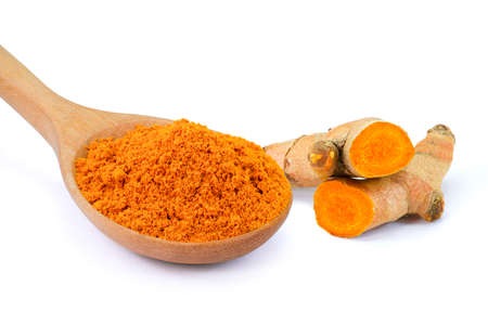 Closeup Turmeric powder ( curcumin, Curcuma longa Linn ) in wooden spoon and tumeric root isolated...