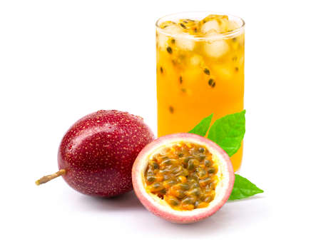 Closeup glass of passionfruit ( maracuya ) juice with passion fruit half slice and green leaf isolated on white background. Healthy drinks concept.の写真素材