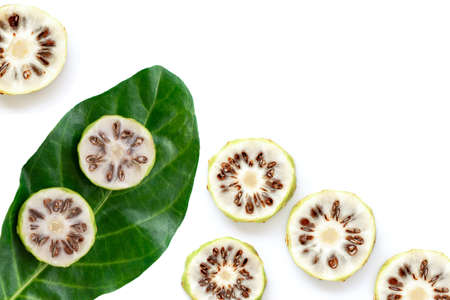 Fresh slices of noni fruit or morinda citrifolia (commom name as indian mulberry, cheese fruit) with...
