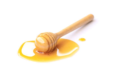 Yellow honey with honeycomb isolated on white background.の写真素材