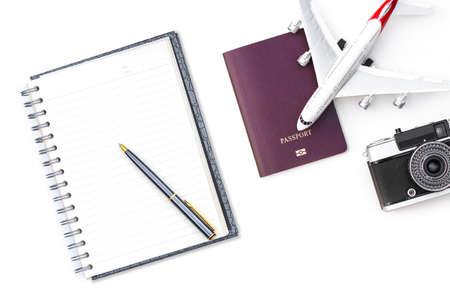 Mockup image of passport, notebook, pen, airplane , camera isolated on white background. Business trip and travel, leisure time concept. Top view. Flat lay.の写真素材