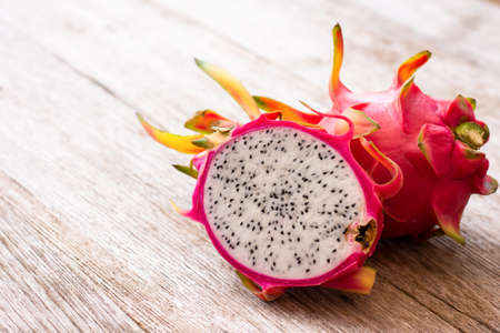 Dragon fruit ( Pitaya or Pitahaya ) with sliced on wooden table background.の写真素材