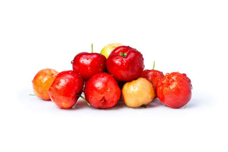 Closeup pile of fresh Acerola cherry isolated on white background.の写真素材