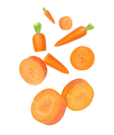 Carrot with cut sliced falling in the air isolated on white background.