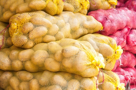 Sacks of Onion and Potato for sale in marketの写真素材