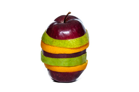 Close view of sliced fruits - apple pear orange guava - concept of diversityの写真素材