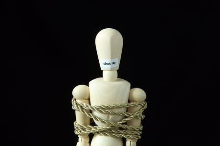 Shut up. Bind a wooden model with rope.の写真素材