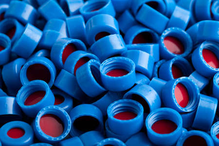Background of blue and red carved plastic caps for chromatographic vials の写真素材