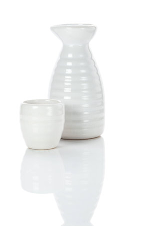 white porcelain traditional japanese jug and shot of sake, isolated with clipping pathの写真素材
