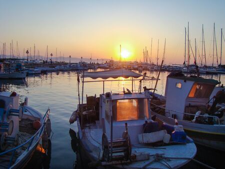 evening sun illuminates the boats in the harbor
