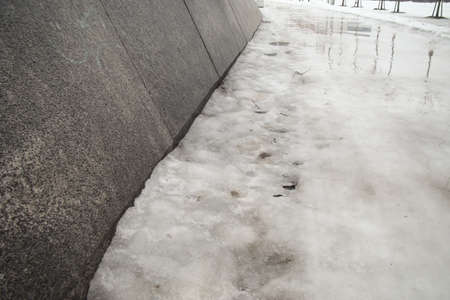 ice track under water along the stone wallの写真素材