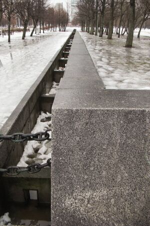 Wet decorative stone gutter park with chainsの写真素材