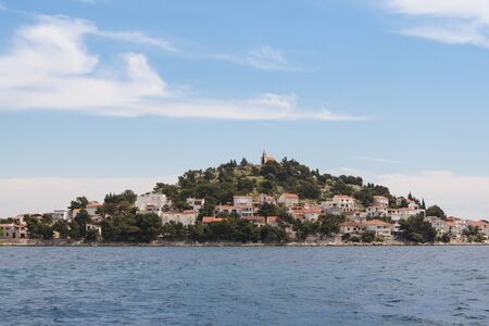 island in the sea with a small townの写真素材