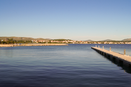 long narrow gangway stretching far into the waterの写真素材