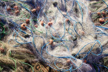 fishing nets with ropes and floats in the heapの写真素材