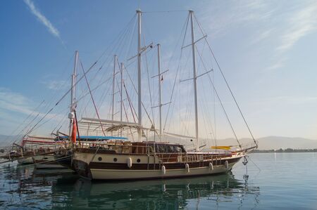 ships at berth on the shiny surface of the waterの写真素材