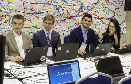 Three young men and a girl at the computer.