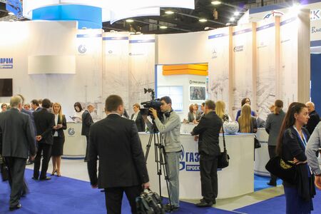 Cameraman among the people on the forum. St. Petersburg, Russia - 6 October, 2015.Expo forum. International Gas Forum.のeditorial素材