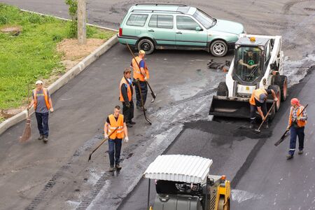 Working with a tool for road works. Leningrad region, Russia - 15 June, 2015. Landscaping and asphalting of yards.のeditorial素材