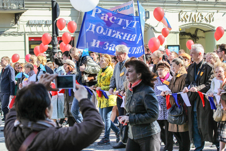 A crowd of people walking. Day festive demonstration on the Nevsky Prospect in St. Petersburg, the first of May.のeditorial素材